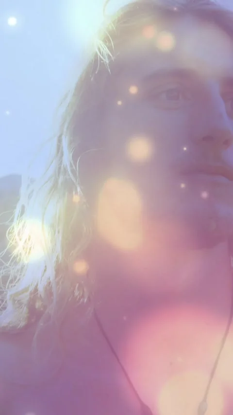 Animation of light spots over caucasian man at beach Stock Footage 342033761