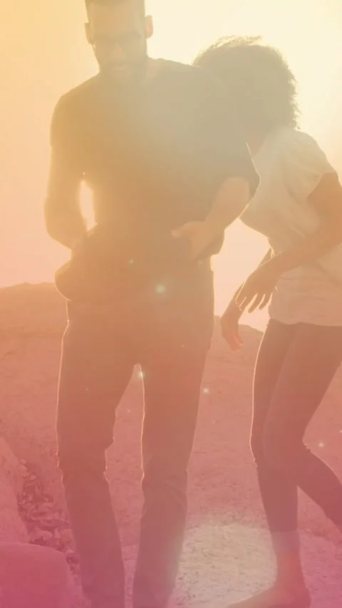 Animation of light spots over couple at beach Vídeo Stock 343504063