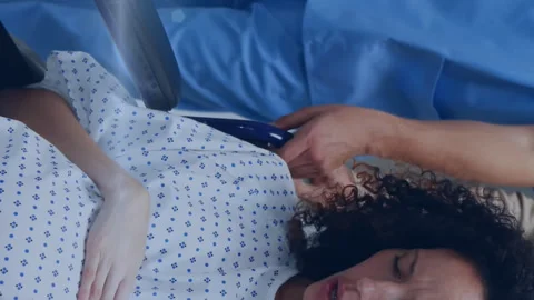 Animation of light spots over pregnant woman with nurse and husband in hospital Stock Footage 313116417
