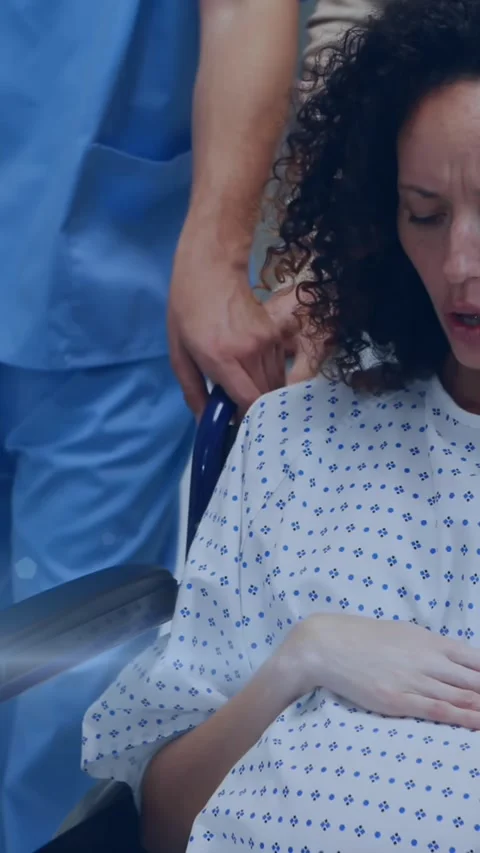 Animation of light spots over pregnant woman with nurse and husband in hospital Stock Footage 324434575