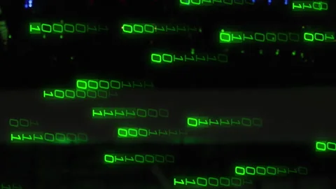 Animation of light trails of binary coding falling against computer server room Video stock 313123244
