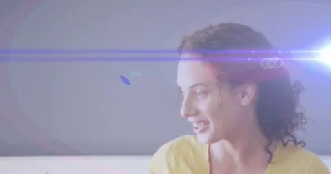 Animation of light trails over caucasian female teacher holding Stock Footage 327900318