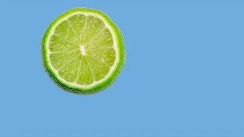 Animation of a lime jumping or hitting the edges of the screen on a blue Stock Footage 201264202