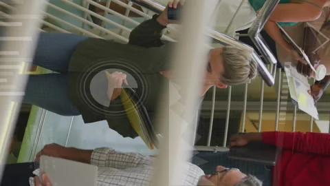 Animation of loading circles and bars over diverse coworkers discussing while Stock Footage 313017363