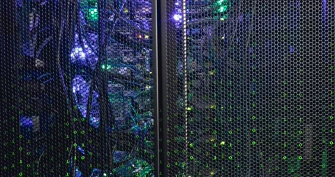 Animation of looping binary codes over illuminated back panel of data server Stock Footage 239789335