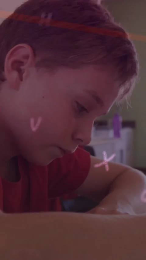 Animation of looping letters and line over caucasian boy writing in book at Stock Footage 344557437