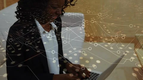 Animation of microprocessor connections over african american woman using laptop Stock Footage 327197753