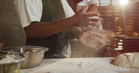 Animation of midsectin of african american male baker clapping hands to clean Stock Footage 341936341