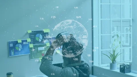 Animation of mixed race man taking off a vr headset And using computer 動画素材 129901094