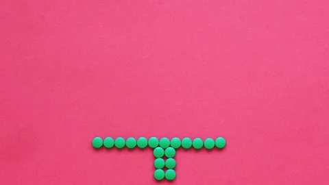 Animation of the movement of a Christmas tree made of green pills on a red Stock-Footage 139963574