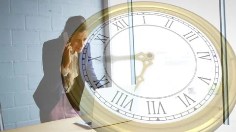 Animation of moving clock over caucasian businesswoman talking on smartphone Stock Footage 310156990