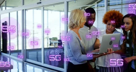 Animation of multiple 5g texts over diverse coworkers discussing reports on Stock Footage 325964833
