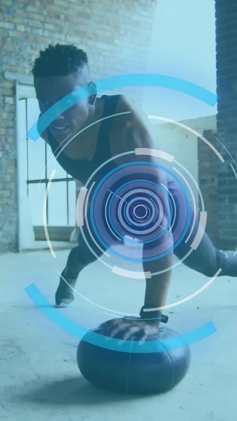 Animation of multiple circles over man exercising with ball in an abandoned Stock Footage 320228579