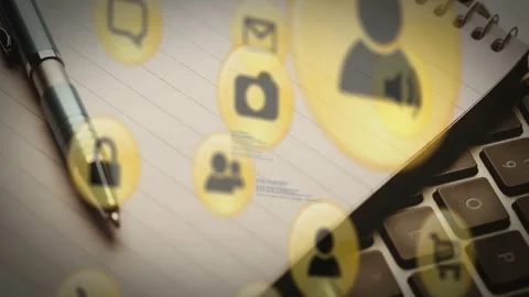 Animation of multiple digital icons against close up of pen, notepad and laptop Stock Footage 328978298