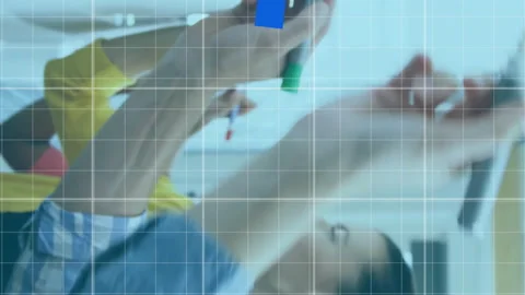 Animation of multiple graphs and grid pattern over diverse coworkers writing on Video stock 313166093
