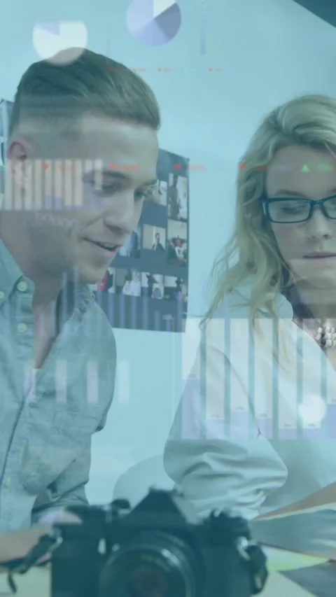 Animation of multiple graphs, icons and trading board over caucasian coworkers Stock Footage 344766083
