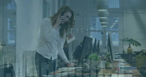 Animation of multiple graphs over caucasian coworkers looking into computer and Stock Footage 248281709