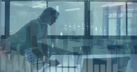 Animation of multiple graphs over caucasian woman standing and using laptop in Stock Footage 253478357