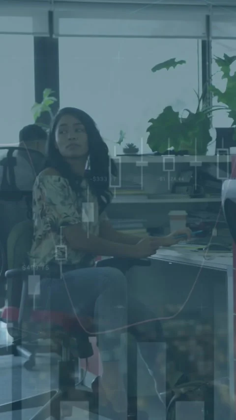 Animation of multiple graphs over diverse coworkers working on computer in Stock Footage 344766096