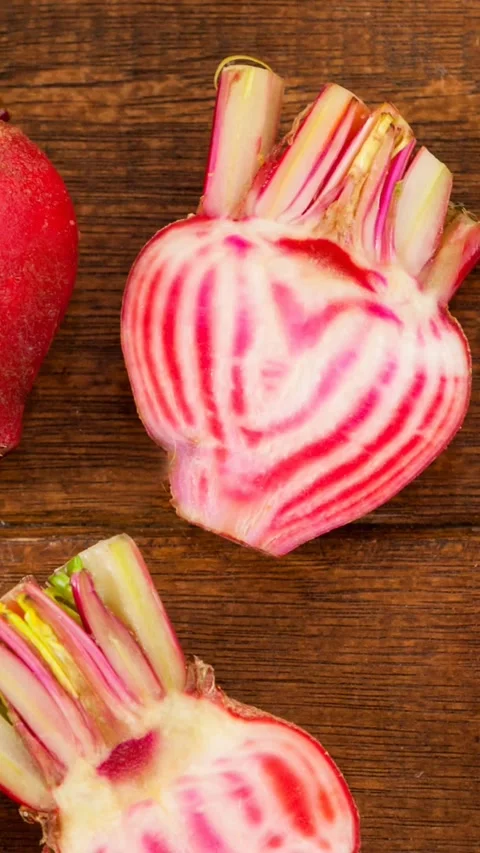 Animation of multiple red beetroots on wooden background Stock Footage 319925659