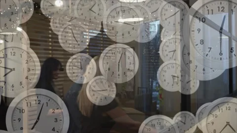 Animation of multiple ticking clocks against diverse colleagues discussing over Stock Footage 329924453