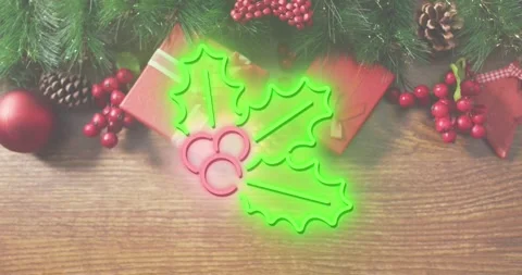 Animation of neon mistletoe icon over christmas gifts and decorations on wooden Stock Footage 330732331
