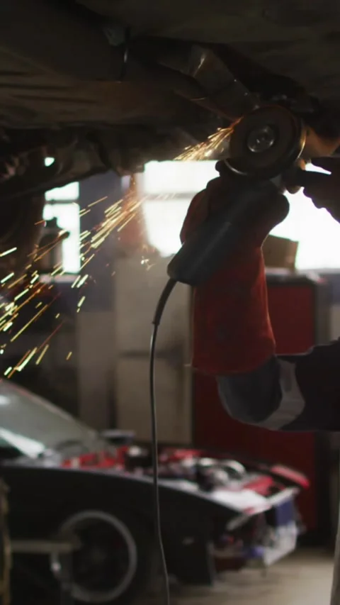 Animation of network of blue hexagons over caucasian woman fixing car Stock Footage 343828376