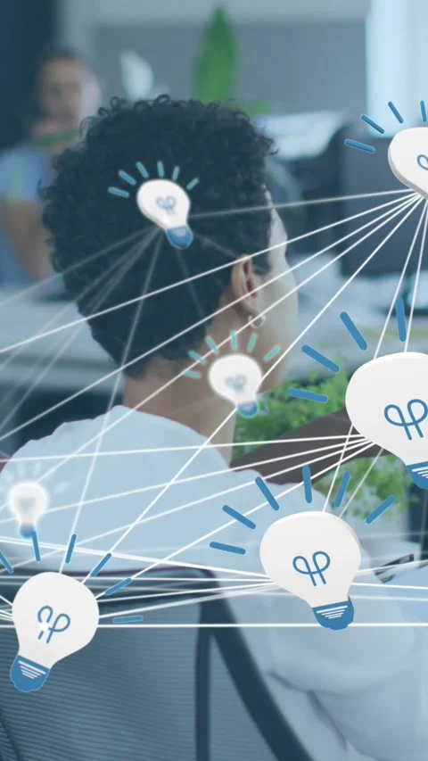 Animation of network of bulb icons over two african american female colleagues Stock Footage 344011844