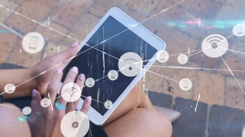 Animation of network of connections with icons over businesswoman using tablet Stock Footage 328926433