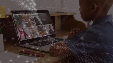 Animation of network of connections over african american boy using laptop for Stock Footage 326763417