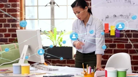 Animation of network of digital icons over asian woman reading documents and Stock Footage 327124714