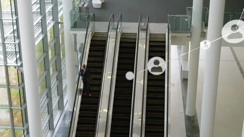 Animation of network of profile icons over businessman on escalator at modern Stock Footage 326032632