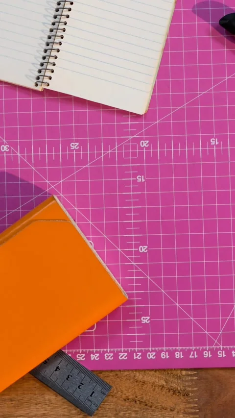 Animation of notepad and craft tools on pink craft mat Stock Footage 319416136