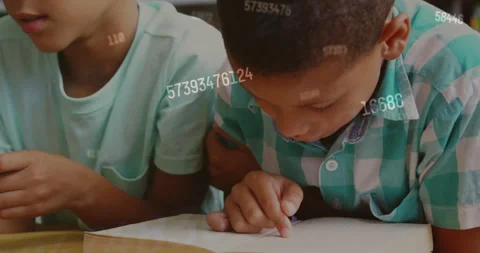 Animation of numbers over schoolboys reading in class Stock Footage 310979170