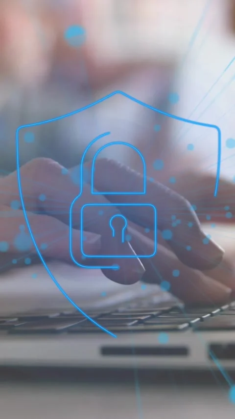 Animation of padlock in shield over cropped hands of caucasian woman working on Stock Footage 321172087
