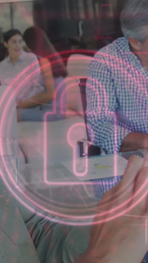 Animation of pink glowing security padlock icon over man using digital tablet at Stock Footage 342009984