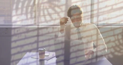 Animation of plants and rain on window over tired caucasian businessman using 動画素材 265954681