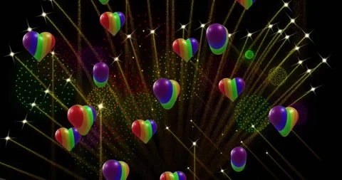 Animation of pride rainbow hearts and fireworks exploding on black background Stock Footage 328969999