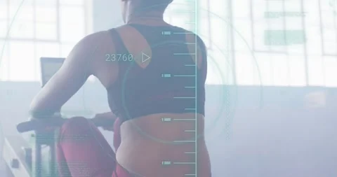 Animation of processing data over woman training on rowing machine at gym Stock Footage 329160543