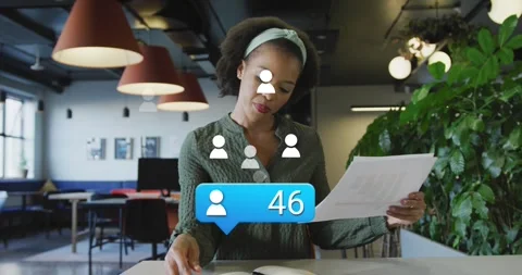 Animation of profile icon floating over african american woman reading documents Stock Footage 329362549