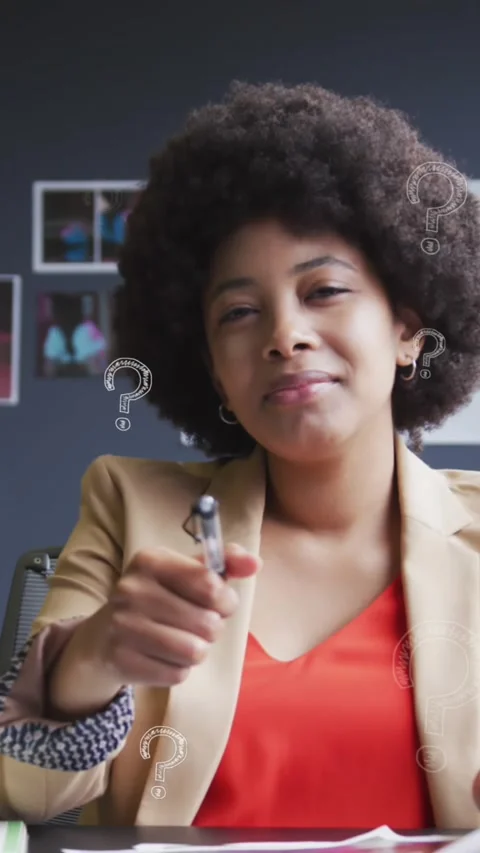 Animation of question mark symbol over businesswoman with afro hair writing in Stock Footage 343644765