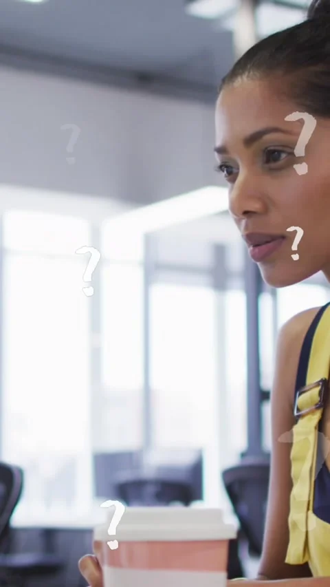Animation of question mark symbols over thoughtful woman using computer at Stock Footage 343644763