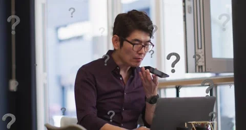 Animation of question marks over asian businessman working at office Stock Footage 328357821