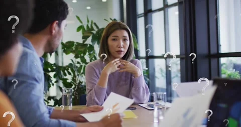 Animation of question marks over diverse business people having meeting at Stock Footage 330254851