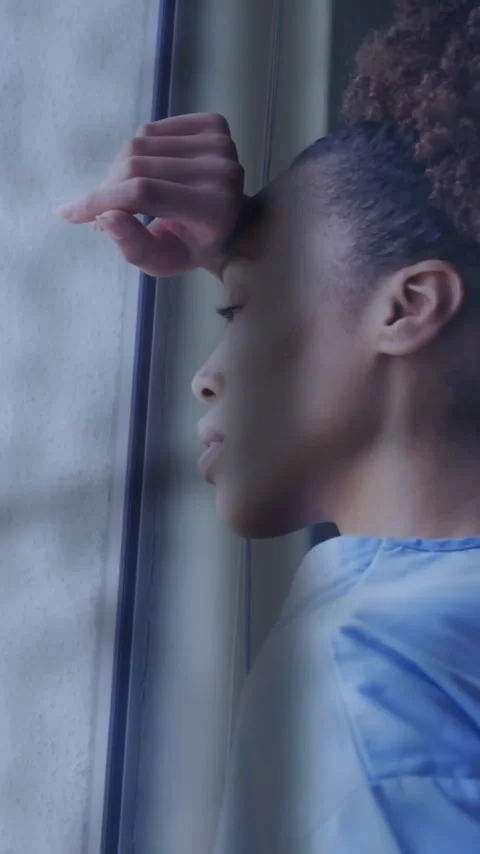 Animation of rain on window over unhappy african american female doctor looking Stock Footage 343714275
