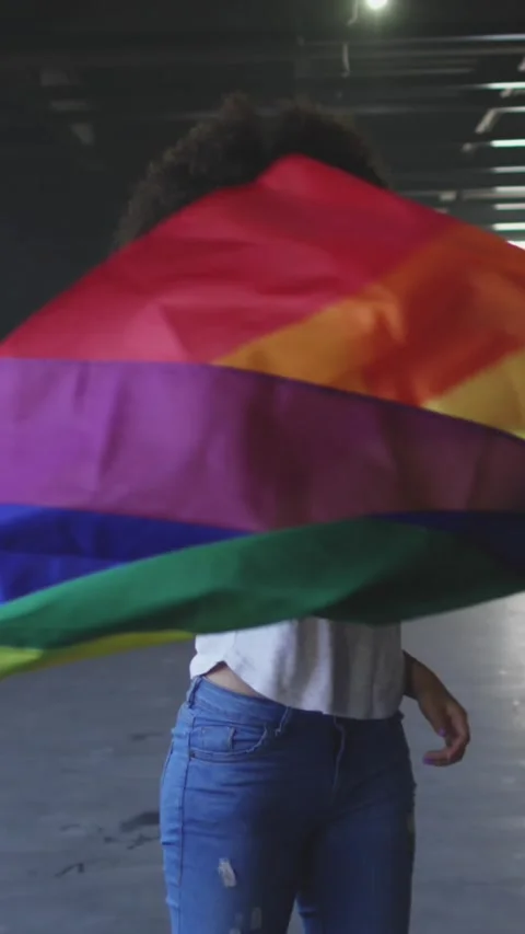 Animation of rainbow pride and unicorn over african american woman with rainbow Stock Footage 342098080