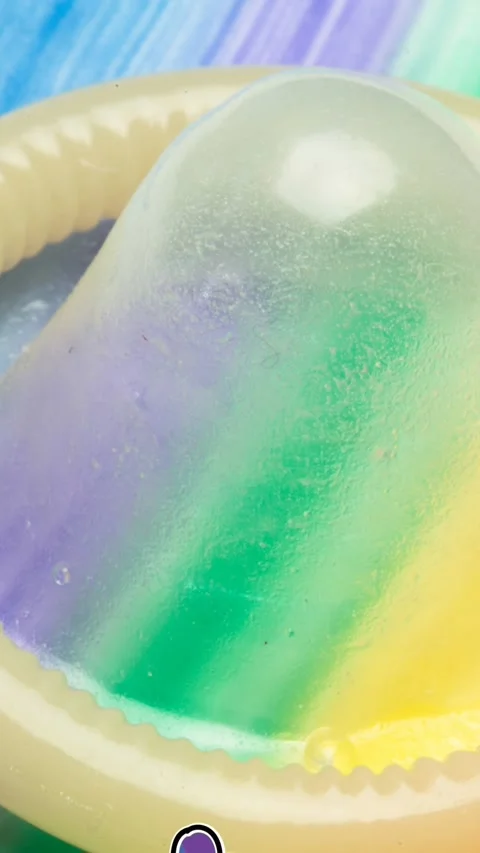 Animation of rainbow victory and pride over condom on rainbow background Stock Footage 342098081