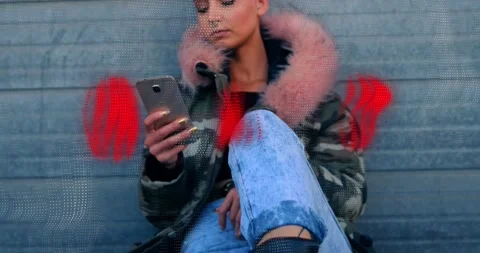 Animation of red abstract patterns over caucasian hipster woman using smartphone Stock Footage 221877835