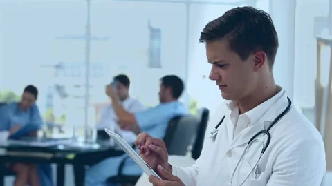 Animation of red pattern over caucasian male doctor using tablet Stock Footage 317113529