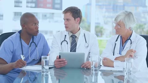 Animation of red pattern over caucasian male doctor using tablet Stock Footage 326758955